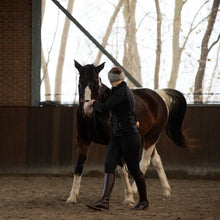 Load image into Gallery viewer, Zyara multi cavesson sidpeull bridle rosegold black + brown used for groundwork with a horse in a riding arena.